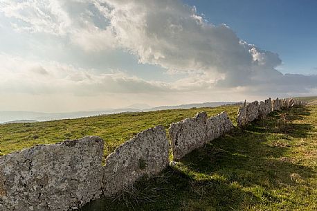 Ancient and typical dry stone wall in Lessinia, Prealps of Veneto, Verona, Italy