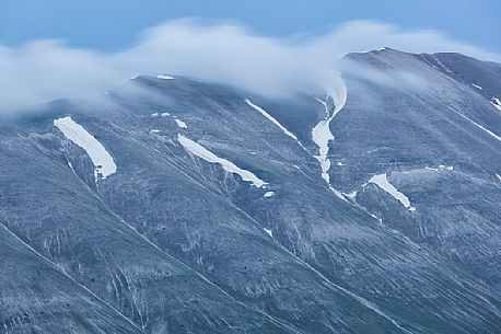 Evening clouds above Monte Vettore mountain, Castelluccio di Norcia, Italy