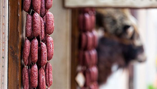 Sausages and salami, typical products on display outside a shop in Norcia, Italy