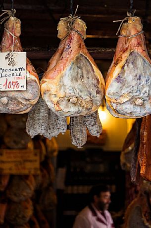 The famous Norcia's ham exposed in one of the many shops in the old town, Norcia, Italy