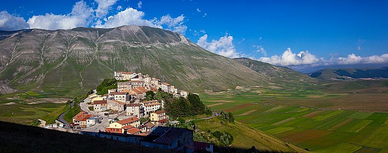 The olf village of Castelluccio before the disastrous earthquake of 2016 in the background the fields planted with lentil, Italy The olf village of Castelluccio before the disastrous earthquake of 2016 in the background the fields planted with lentil, Italy
