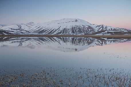 Thaw on the Pian Grande of Castelluccio di Norcia, in the background the Vettore mountain, Sibillini National Park Thaw on the Pian Grande of Castelluccio di Norcia, in the background the Vettore mountain, Sibillini National Park