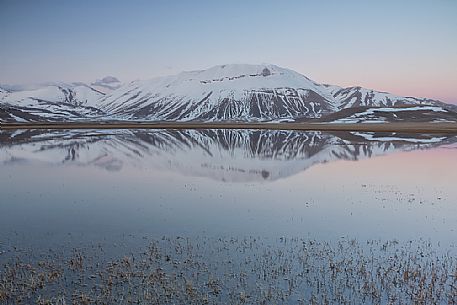 Thaw on the Pian Grande of Castelluccio di Norcia, in the background the Vettore mountain, Sibillini National Park