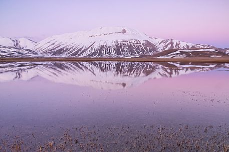 Thaw on the Pian Grande of Castelluccio di Norcia, in the background the Vettore mountain, Sibillini National Park Thaw on the Pian Grande of Castelluccio di Norcia, in the background the Vettore mountain, Sibillini National Park