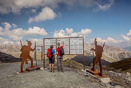 Hikers at Garibaldi peak or Dreisprachenspitze, in the background the swiss alps, Stelvio pass, Stelvio national park, Italy Hikers at Garibaldi peak or Dreisprachenspitze, in the background the swiss alps, Stelvio pass, Stelvio national park, Italy