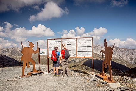 Hikers at Garibaldi peak or Dreisprachenspitze, in the background the swiss alps, Stelvio pass, Stelvio national park, Italy Hikers at Garibaldi peak or Dreisprachenspitze, in the background the swiss alps, Stelvio pass, Stelvio national park, Italy