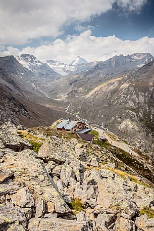 Martello hut and in the background the glacier of Cevedale mount and Gran Zebrù peak, Stelvio national park, Italy Martello hut and in the background the glacier of Cevedale mount and Gran Zebrù peak, Stelvio national park, Italy
