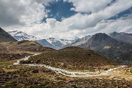 Along the glacier path of the Martello valley, in the background the Cevedale glacier and Gran Zebrù peak, Stelvio national park, Italy Along the glacier path of the Martello valley, in the background the Cevedale glacier and Gran Zebrù peak, Stelvio national park, Italy