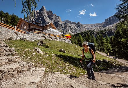 Hiker at Contrin hut, in the background the Marolada range, dolomites, Italy Hiker at Contrin hut, in the background the Marolada range, dolomites, Italy