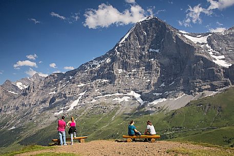 Tourists admiring the famous north face of Eiger mount, Mannlichen, Grindelwald, Berner Oberland, Switzerland, Europe
 