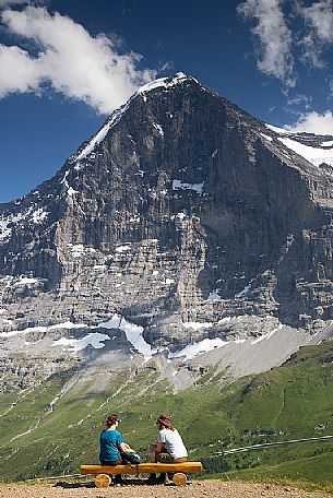Tourists admiring the famous north face of Eiger mount, Mannlichen, Grindelwald, Berner Oberland, Switzerland, Europe
 