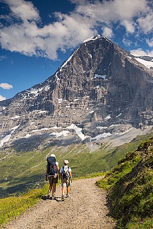 Mother and child in the path from Mannlichen to Kleine Scheidegg, in front the famous north face of Eiger mount and the Jungfrau mountain group, Grindelwald, Berner Oberland, Switzerland, Europe
 