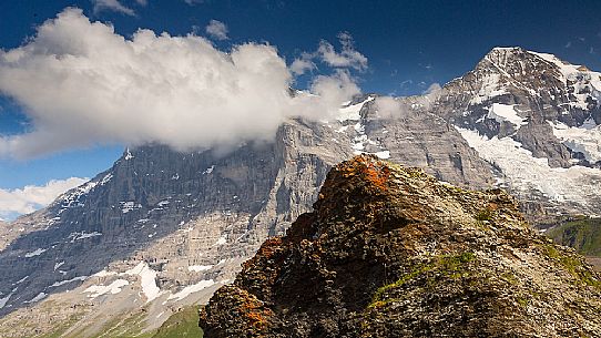 In front of the famous north face of Eiger mount in the clouds and the Jungfrau mountain group, Mannlichen, Grindelwald, Berner Oberland, Switzerland, Europe
 