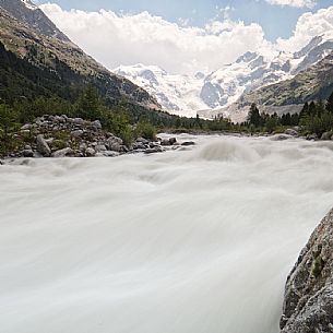 Wild creek in Val Morteratsch valley with Morteratsch Glacier and Bernina mountain group, Engadin, Pontresina, Graubunden, Switzerland, Europe
 