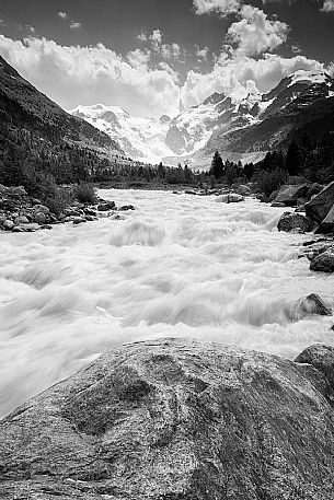 Wild creek in Val Morteratsch valley with Morteratsch Glacier and Bernina mountain group, Engadin, Pontresina, Graubunden, Switzerland, Europe
 