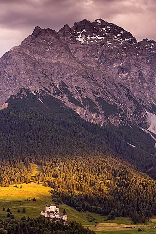 Tarasp Castle at sunset and Mountain of Swiss national park, Lower Engadin, Canton of Grisons, Switzerland, Europe