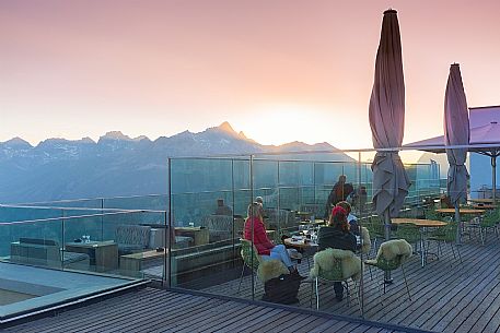 Tourists in the terrace of Romantik Hotel Muottas Muragl at sunset, Muottas Muragl, Samedan, Engadin, Canton of Grisons, Switzerland, Europa