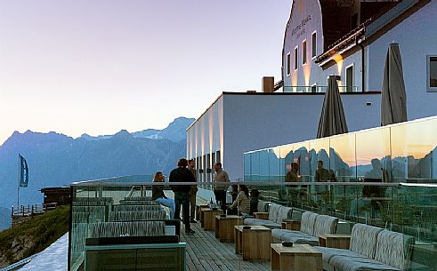 Tourists in the terrace of Romantik Hotel Muottas Muragl at sunset, Muottas Muragl, Samedan, Engadin, Canton of Grisons, Switzerland, Europa