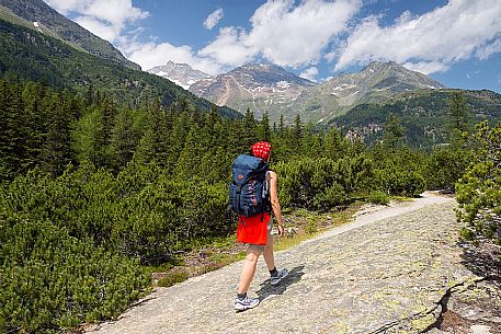 Hiker in the Cavaglia Glacial Garden  also referred to as Giants Pots, Cavaglia, Poschiavo valley, Engadin, Canton of Grisons, Switzerland, Europe