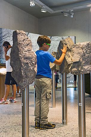 Child visiting the permanent exhibition in Swiss National Park visitor center in Zernez, Engadin, canton of Grisons, Switzerland, Europe