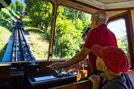Inside the red Cogwheel Railway going up Pilatus Mountain, Border Area between the Cantons of Lucerne, Nidwalden and Obwalden, Switzerland, Europe Inside the red Cogwheel Railway going up Pilatus Mountain, Border Area between the Cantons of Lucerne, Nidwalden and Obwalden, Switzerland, Europe