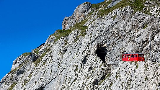 The red Cogwheel Railway going up Pilatus Mountain, Border Area between the Cantons of Lucerne, Nidwalden and Obwalden, Switzerland, Europe