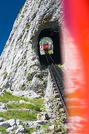 The red Cogwheel Railway going up Pilatus Mountain, Border Area between the Cantons of Lucerne, Nidwalden and Obwalden, Switzerland, Europe