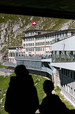 Tourists silhouette looking the Pilatus Klum hotel on Pilatus mountain from summit station of Cogwheel Railway , Lucerne, Border Area between the Cantons of Lucerne, Nidwalden and Obwalden, Switzerland, Europe Tourists silhouette looking the Pilatus Klum hotel on Pilatus mountain from summit station of Cogwheel Railway , Lucerne, Border Area between the Cantons of Lucerne, Nidwalden and Obwalden, Switzerland, Europe