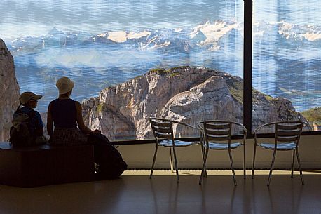 Tourists silhouette looking the panorama of mountains of the Bernese Oberland from summit station of Pilatus Cogwheel Railway , Lucerne, Border Area between the Cantons of Lucerne, Nidwalden and Obwalden, Switzerland, Europe