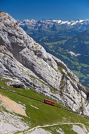 The red Cogwheel Railway going up Pilatus Mountain, Border Area between the Cantons of Lucerne, Nidwalden and Obwalden, Switzerland, Europe