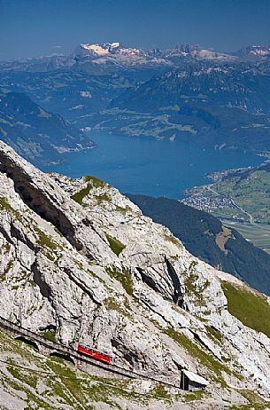 The red Cogwheel Railway going up Pilatus Mountain, in the background the Lucerna lake, Border Area between the Cantons of Lucerne, Nidwalden and Obwalden, Switzerland, Europe