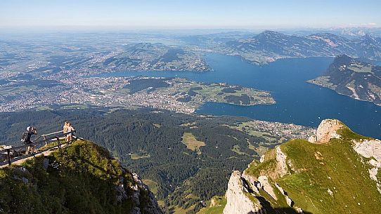 Tourists at the belvedere of Pilatus mount, in the background of the city and the lake of Lucerne, border Area between the Cantons of Lucerne, Nidwalden and Obwalden