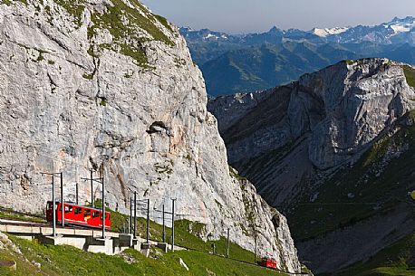 The red Cogwheel Railway going up Pilatus Mountain, Border Area between the Cantons of Lucerne, Nidwalden and Obwalden, Switzerland, Europe