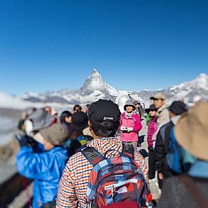 Tourists in the top of Gornergrat admiring  the Matterhorn or Cervino mountain peak, Zermatt, Valis, Switzerland, Europe