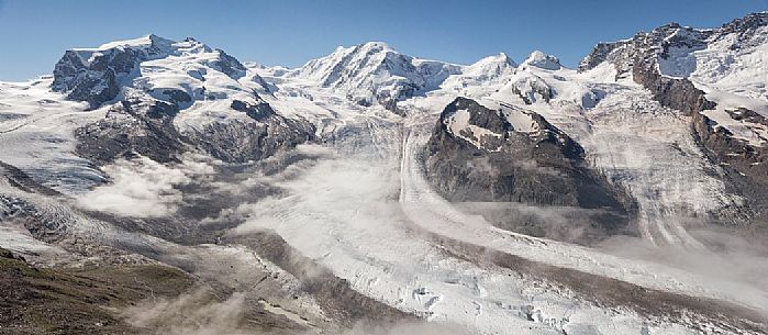 View from Gornergrat mountain towards Monte Rosa or Breithorn mountain range with Liskamm and Gorner Glacier in the clouds, Zermatt, Valais, Switzerland, Europe
 