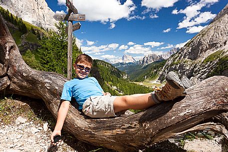 Child lying in the old tree near Falier mountain hut, Val Ombretta, Marmolada mountain range, dolomites, Veneto, Italy, Europe Child lying in the old tree near Falier mountain hut, Val Ombretta, Marmolada mountain range, dolomites, Veneto, Italy, Europe