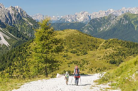 Mother and child near the source of the Piave river and in the background the dolomites of Cadore, Sappada, dolomites, Friuli Venezia Giulia, Italy, Europe Mother and child near the source of the Piave river and in the background the dolomites of Cadore, Sappada, dolomites, Friuli Venezia Giulia, Italy, Europe