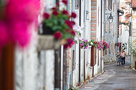 Women walking in the alley of the small village of Andreis, Friuli Venezia Giulia, dolomites, Italy, Europe Women walking in the alley of the small village of Andreis, Friuli Venezia Giulia, dolomites, Italy, Europe