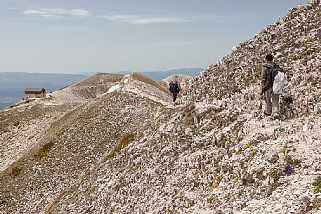 Hikers and Duca degli Abruzzi hut in the Gran Sasso national park, Abruzzo, Italy, Europe