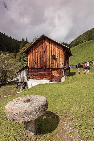 Tourists visit the ancient water mill in the Mulini valley, Longiar, Badia valley, Trentino Alto Adige, Italy, Europe