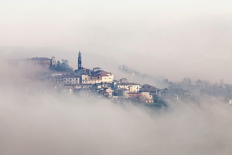 The small village of Frassinello Monferrato in the fog, Monferrato, Piedmont, Italy, Europe The small village of Frassinello Monferrato in the fog, Monferrato, Piedmont, Italy, Europe