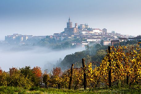 The wineyards in front of Camagna Monferrato in autumn in a foggy day, Monferrato, Piedmont, Italy, Europe