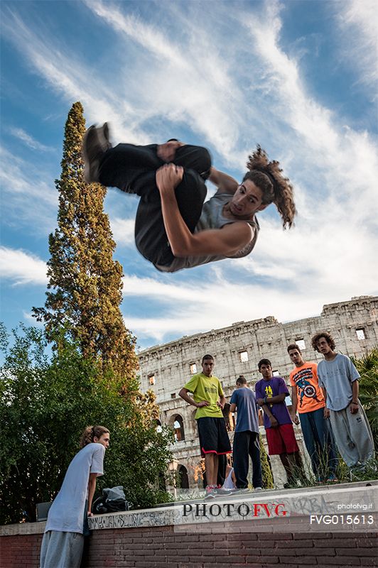 Some young freerunners jumping in front of the Colosseum in Rome.