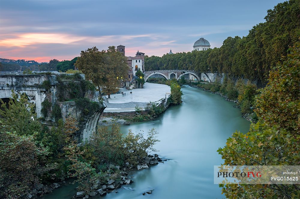 Beautiful and sweet sunset near the tiber Island. The Tiber Island is the only island in the Tiber river which runs through Rome and and has been connected with bridges to both sides of the river since antiquity