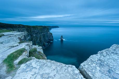 Rocks into the foreground along the Cliffs of Moher's path, during the blue hour Rocks into the foreground along the Cliffs of Moher's path, during the blue hour