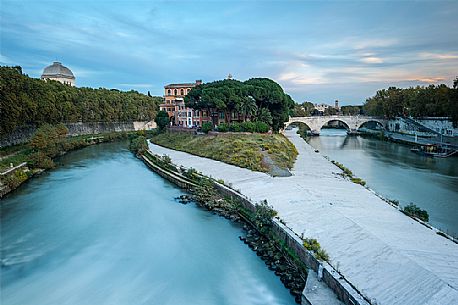 The Tiber Island is the only island in the Tiber river which runs through Rome and and has been connected with bridges to both sides of the river since antiquity The Tiber Island is the only island in the Tiber river which runs through Rome and and has been connected with bridges to both sides of the river since antiquity