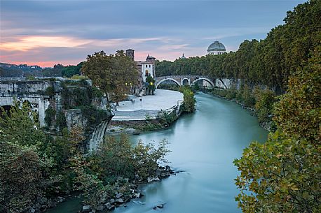 Beautiful and sweet sunset near the tiber Island. The Tiber Island is the only island in the Tiber river which runs through Rome and and has been connected with bridges to both sides of the river since antiquity