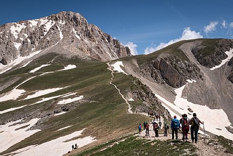 A group of hikers proceed towards the summit of the Gran Sasso, Gran Sasso national park, Abruzzo, Italy, Europe
