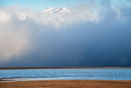 Campotosto lake and Gran Sasso mountain range in the cluods, Gran Sasso national park, Abruzzo, Italy, Europe