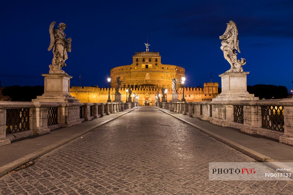 Castel Sant'Angelo and the bridge Sant'Angelo illuminated with the blue sky before the dawn